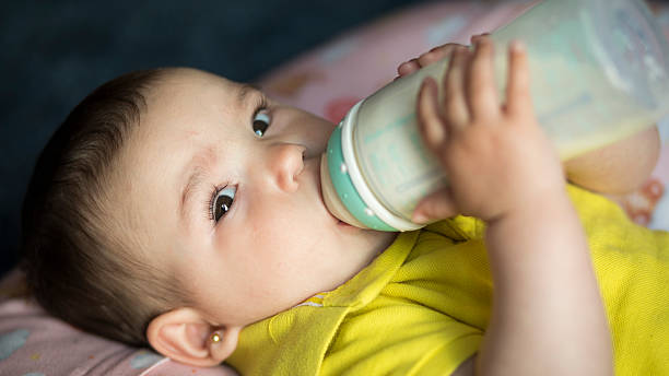 istock baby fed with formula milk from a bottle 2214104790