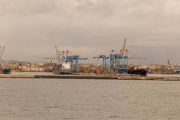 A harbor with many colorful boats and a cloudy sky