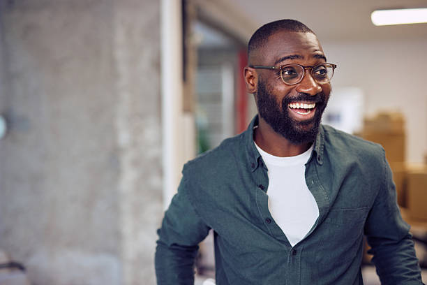istock Young businessman smiling and looking away in modern office 2214106179