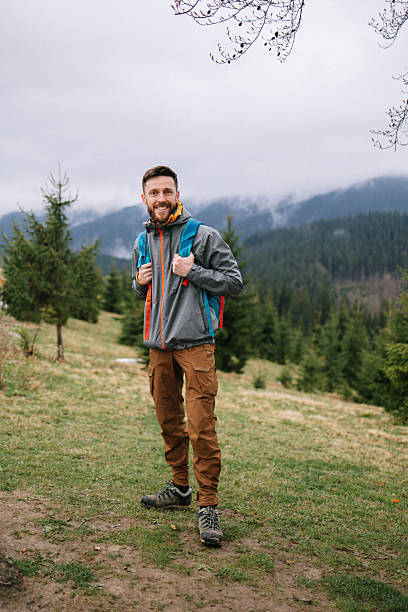istock Cheerful man at the hiking in the spring mountains 2214106210