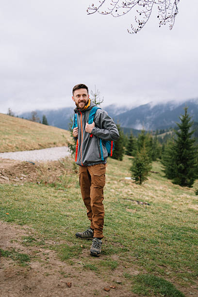 istock Cheerful man at the hiking in the spring mountains 2214106221
