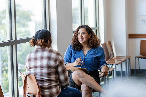istock Two Women in Casual Clothing Having a Discussion 2214106925