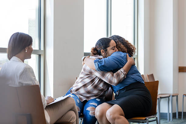 istock Group Therapy Session: Women Embracing, Showing Emotional Support 2214106927