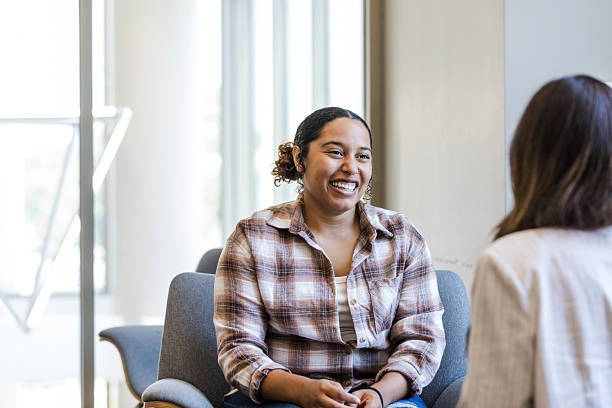 istock Happy Young Woman in Counseling Session, Smiling 2214106941