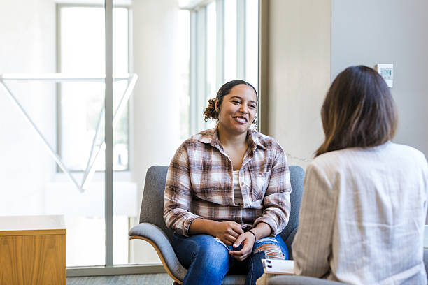 istock Cheerful Woman in Plaid Shirt During Counseling Session 2214106948
