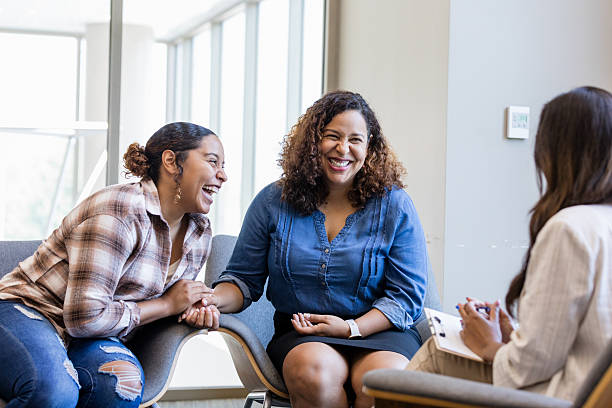 istock Happy Women in Group Therapy Session, Smiling and Talking 2214106956