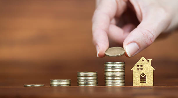 istock Money coins with hand and house, financial solution background 2214108155