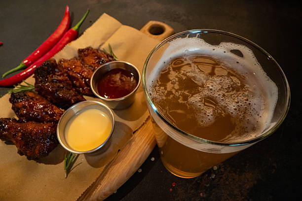 Closeup of chicken wings with dips served at restaurant for design purpose