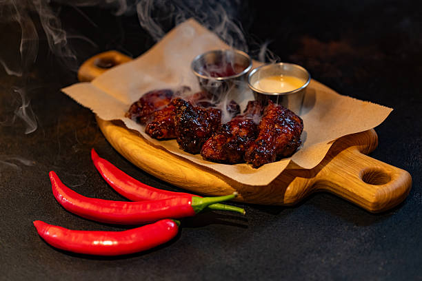 Closeup of chicken wings with dips served at restaurant for design purpose
