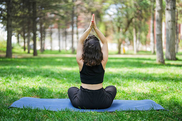 istock Woman Practicing Yoga Outdoors in a Peaceful Park Setting 2214113889