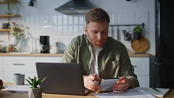 istock Man accountant using calculator at home office closeup. Manager working laptop 2214115714