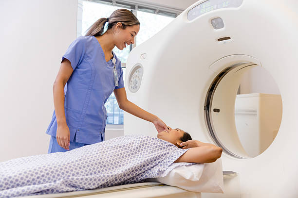 istock Cheerful Nurse Comforting Patient Before CT Scan 2214115807