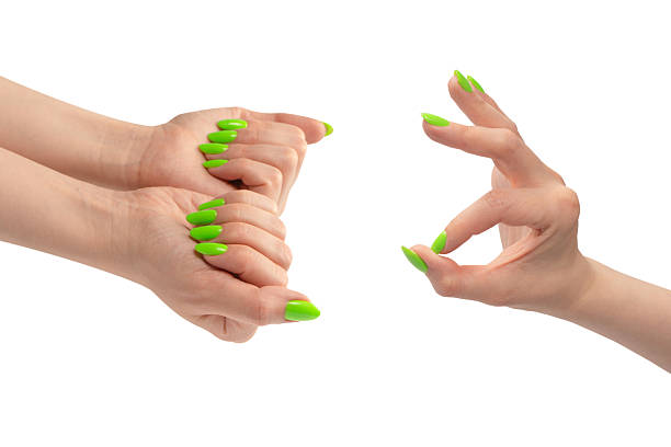 istock Hand of a woman with green naols hold some tiny or thin object. 2214118634