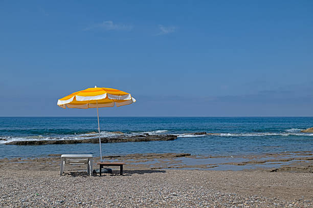 Yellow colored parasols and sunbeds on the beach.
