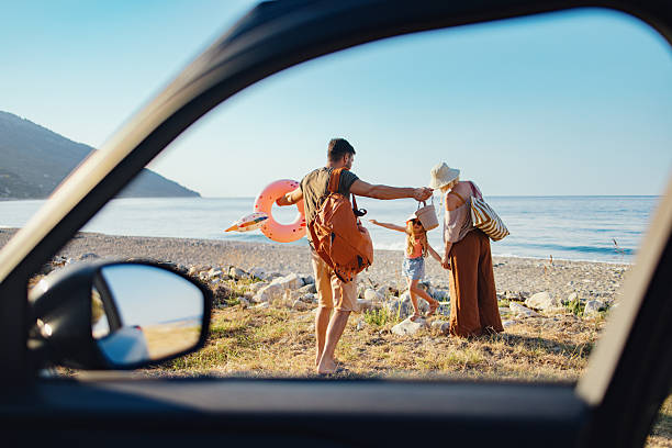 istock Family Enjoying a Beach Vacation Seen Through a Car Window 2214123120