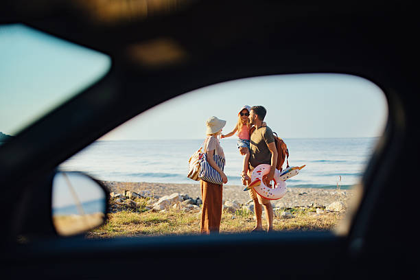 istock Family Framed Through a Car Window on a Beach Vacation 2214123143