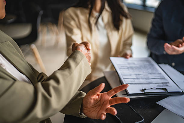 istock young japanese entrepreneur shake hands with financial adviser 2214123372