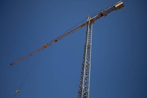 istock A Tower Crane Stands Against a Clear Blue Sky, Symbolizing Modern Construction Efforts 2214127645