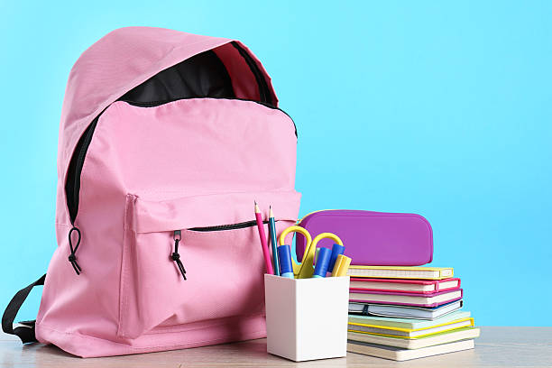 istock Backpack with different school stationery on wooden table against light blue background, space for text 2214128798