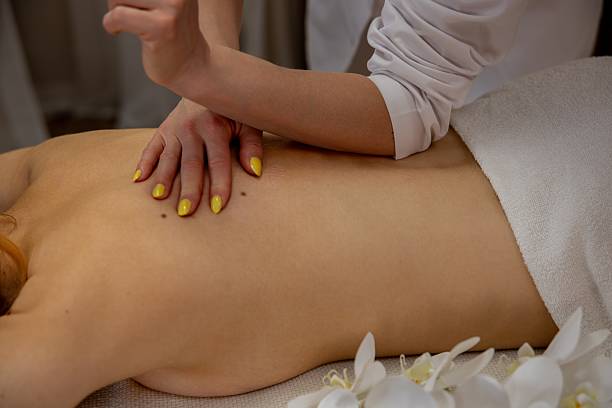 istock Experience a Relaxing and Invigorating Massage Therapy Session with Beautiful Floral Accents 2214130866