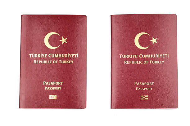 istock Two Turkish passports lying side by side isolated on a white background 2214136162