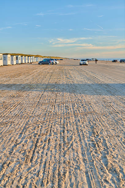 istock Scenic coastal view featuring vehicles on a sandy beach in Denmark 2214137746