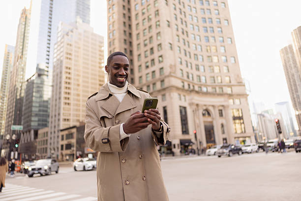 istock Smiling businessman using smartphone in chicago downtown 2214138279