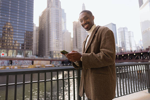 istock Businessman using smartphone in chicago riverwalk, illinois 2214138281