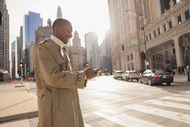 istock Businessman using smartphone on chicago street corner 2214138284