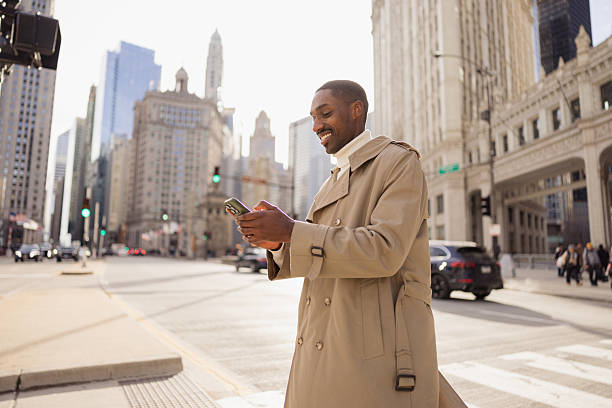 istock Smiling businessman using smartphone in chicago downtown 2214138296
