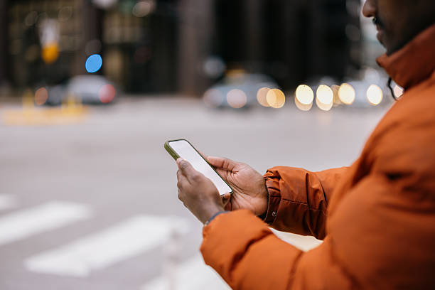 istock Man using smartphone on a city street corner 2214138469