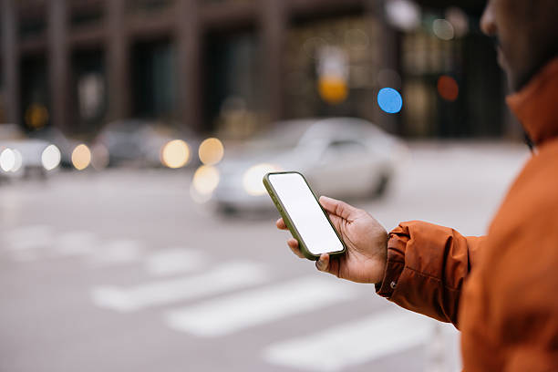 istock Man using smartphone with white screen in city street 2214138475