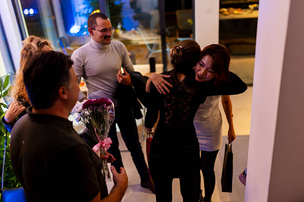 istock Friendly gathering featuring heartfelt hugs and gift giving in a modern home atmosphere 2214145671