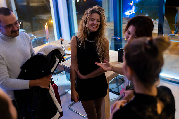 istock Group of people enjoying a social gathering in a modern lit setting 2214145677