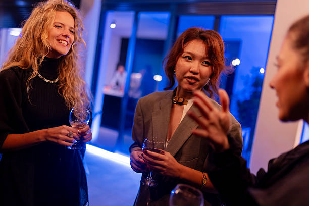 istock Group of people enjoying a lively conversation at a modern evening gathering 2214145698