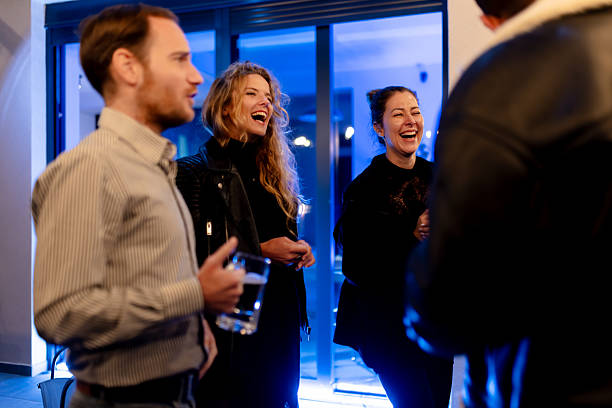istock Group of friends sharing laughter and drinks at an evening gathering 2214145743