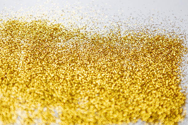 istock Gold glitters on a white background. Golden texture with glitter sparkles. Bright design for Banners, Greeting Gold Cards, Luxury Invitation, Certificate. 2214147186