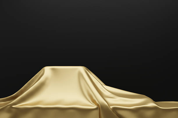 istock Empty podium covered with gold fabric for product display with 3D render copy space 2214149219