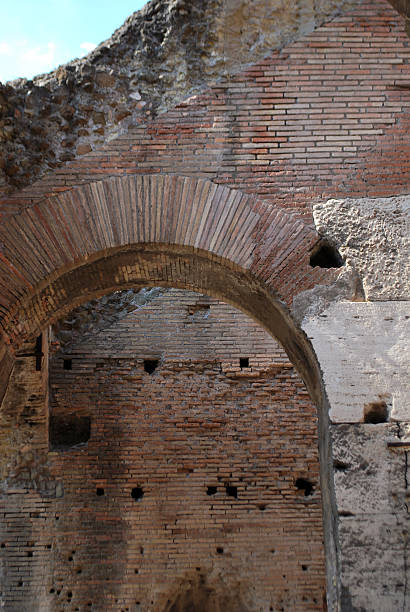 istock Vertical Brick Arch in a Weathered Roman Wall 2214153956