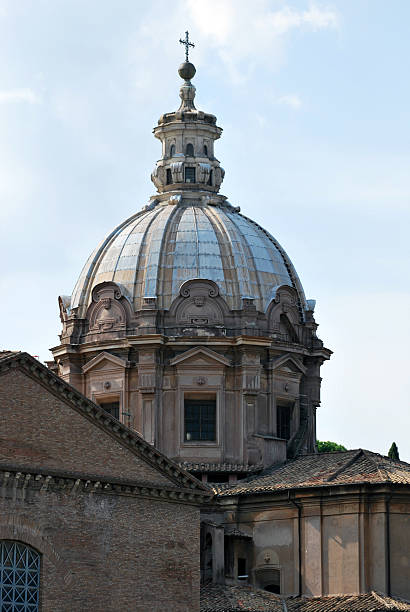 A close-up of the beautifully restored dome of Santi Luca e Martina, located near the Roman Forum. The detailed Baroque architecture and prominent cross atop the dome make it a visual anchor in the historic cityscape.