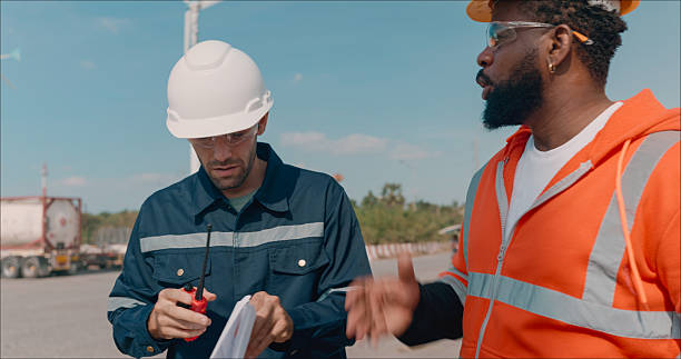 istock A Caucasian male electrical engineer with a Black technician discussing Brainstorming and reviewing precise blueprints for maintenance of a wind turbine or windmill on top of the wind turbine.Sustainability, renewable, clean energy concept. 2214155296