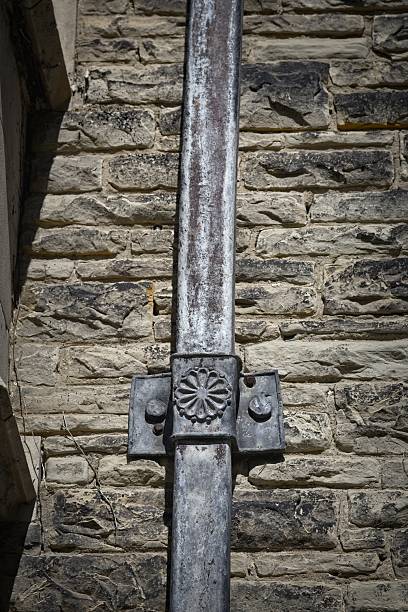 istock Decorative Metal Downspout on Stone Wall 2214156739