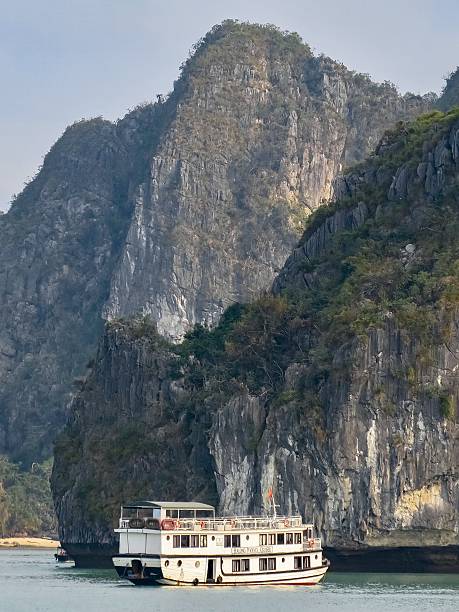 istock A Boat Dwarfed by a Karst Islet in Halong Bay 2214161462