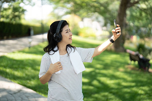 istock Wellness and joy: Elderly woman taking a selfie while walking 2214162435