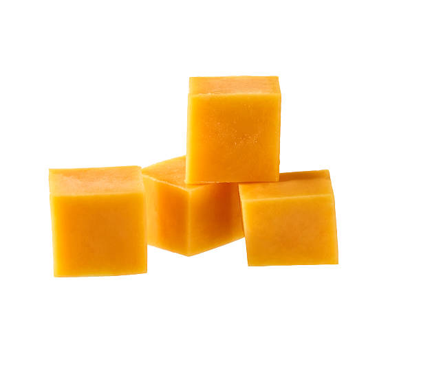 istock cheddar cheese sliced ​​into cubes isolated on white background. 2214164942