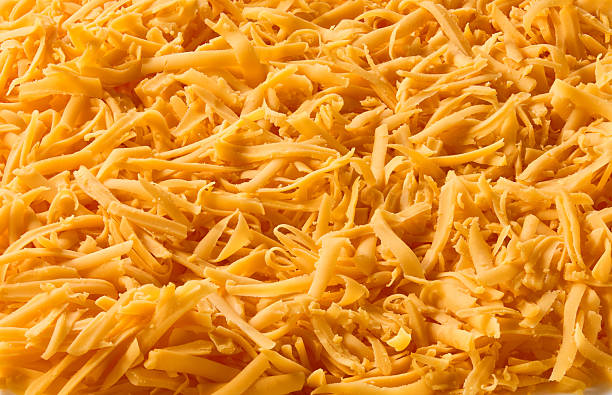istock texture of grated cheddar cheese, food background. 2214165049