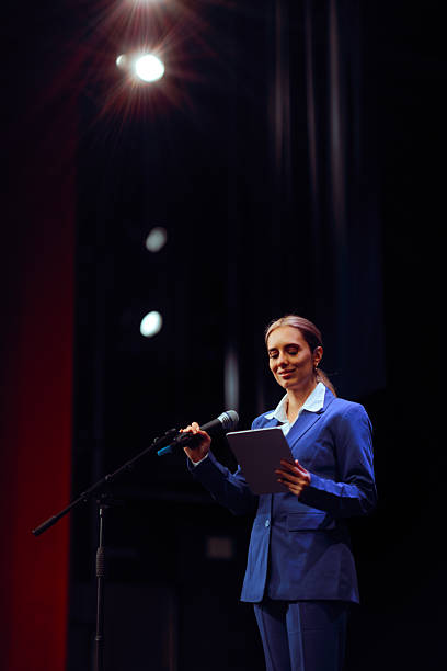 istock Woman Holding a Tablet and Speaking into a Microphone 2214167534