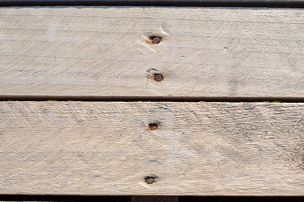 Background of light wooden boards with nails. Construction and carpentry.