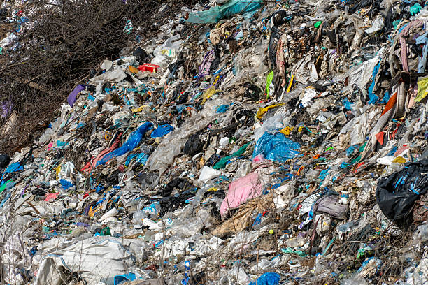istock Overflowing Rubbish Dump Covered in Trash and Discarded Plastic Materials Creating Pollution and Waste on a Sunny Day 2214173574