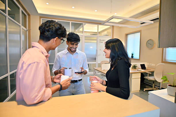 istock Young professionals enjoying coffee break in a modern office 2214173787